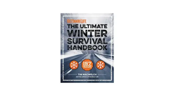 Okładka książki "The Ultimate Winter Survival Handbook" z drogą w zimowym krajobrazie.